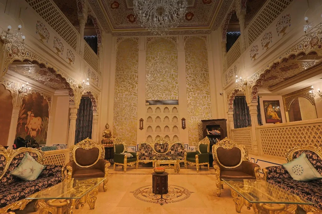 Grand lobby with crystal chandelier and gold-gilt seating — Traditional Heritage Haveli, Jaipur Grand lobby with crystal chandelier and gold-gilt seating — Traditional Heritage Haveli, Jaipur